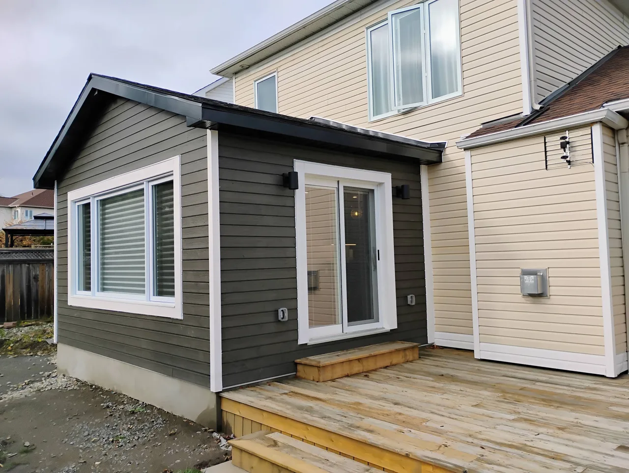 A completed Zacconi rear home addition with grey siding